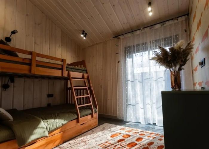 Panoramic house in a coniferous forest with sauna