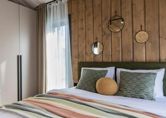 Panoramic house in a coniferous forest with sauna