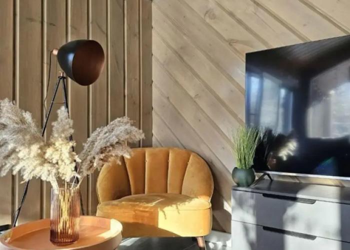 Panoramic house in a coniferous forest with sauna